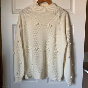 Cream sweater with pompom details